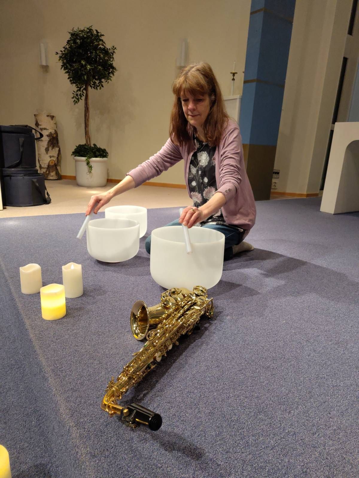 A picture of Maggan playing the crystal bowls.